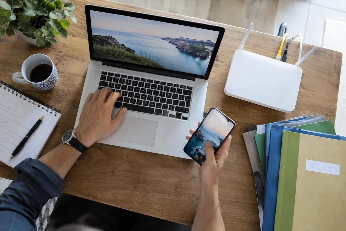 A computer, a phone and neatly organised files